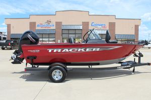 2025 Tracker Pro Guide V-175 Combo boat in red, parked outside a dealership.