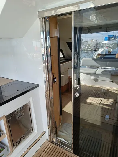 Feel So Good Yacht Photos Pics Luxury yacht interior with sliding glass door, showcasing modern design. Privilege 640, 2021 model.