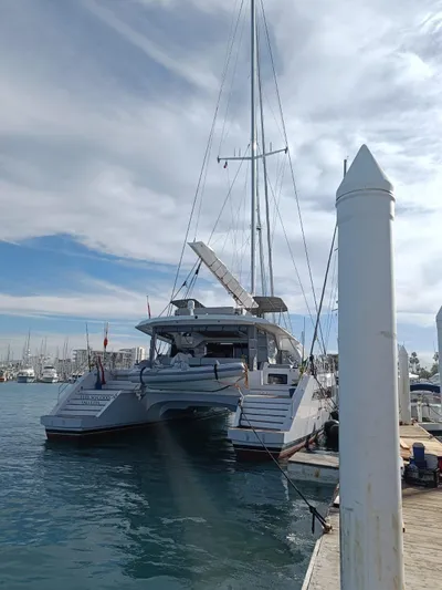 Feel So Good Yacht Photos Pics Luxury Privilege 640 catamaran docked at marina, 2021 model, under a partly cloudy sky.