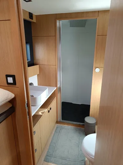 Feel So Good Yacht Photos Pics Modern bathroom interior on 2021 Privilege 640 yacht, featuring wooden cabinetry and sleek design.