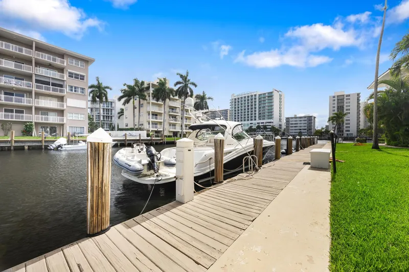  Yacht Photos Pics 2008 Sea Ray 44 Sundancer docked at a marina with waterfront buildings and palm trees.