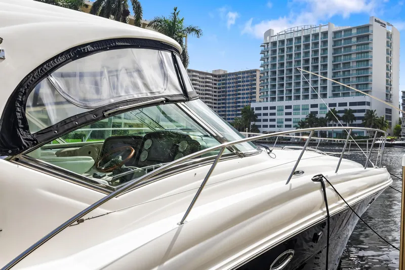  Yacht Photos Pics 2008 Sea Ray 44 Sundancer yacht docked near modern waterfront buildings.