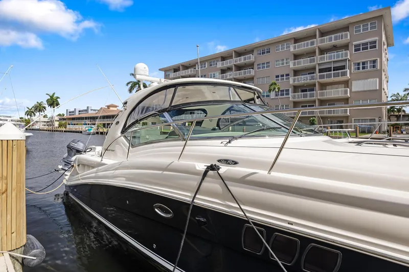 Yacht Photos Pics 2008 Sea Ray 44 Sundancer yacht docked near waterfront apartments.