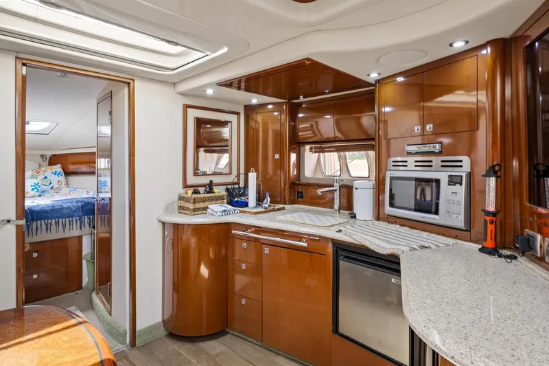  Yacht Photos Pics Luxurious 2008 Sea Ray 44 Sundancer yacht interior with modern kitchen and cozy bedroom.
