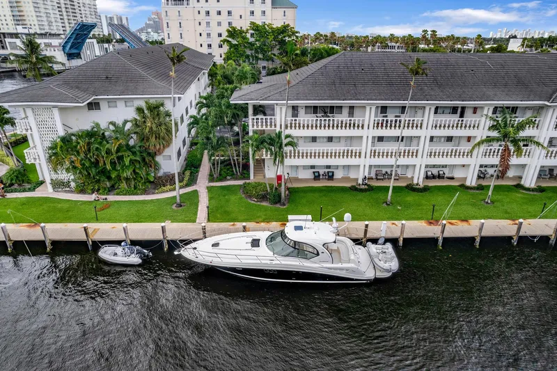  Yacht Photos Pics 2008 Sea Ray 44 Sundancer yacht docked near waterfront buildings.