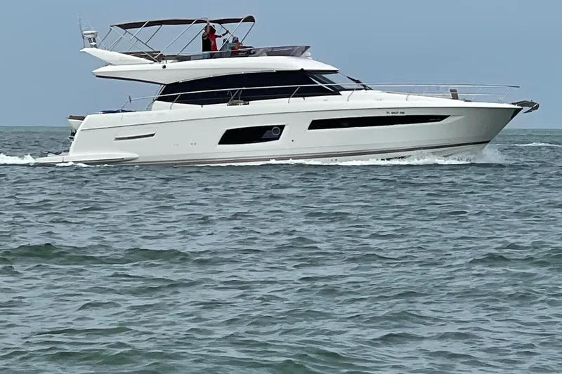 Just Peachy Yacht Photos Pics 2015 Prestige 550 Fly yacht cruising on open water.