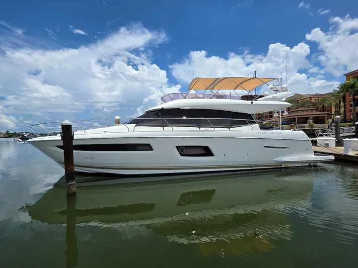 Just Peachy Yacht Photos Pics 2015 Prestige 550 Fly yacht docked under a clear blue sky.