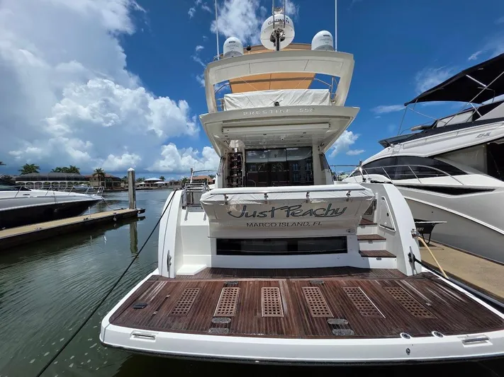 Just Peachy Yacht Photos Pics 2015 Prestige 550 Fly yacht docked at marina under blue sky.
