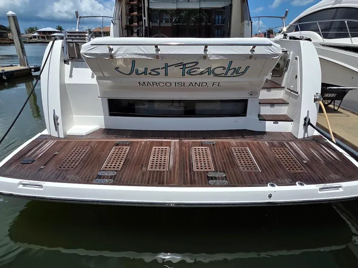 Just Peachy Yacht Photos Pics Prestige 550 Fly yacht, 2015 model, docked in Marco Island, FL, with "Just Peachy" name.