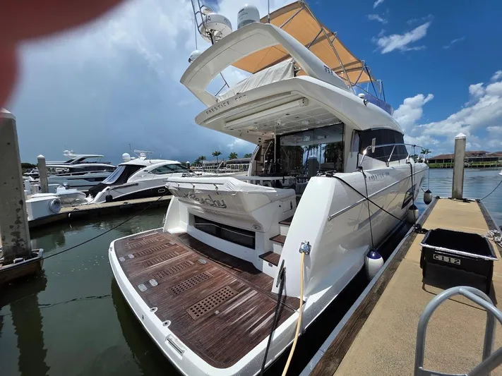 Just Peachy Yacht Photos Pics 2015 Prestige 550 Fly yacht docked at marina under clear blue sky.