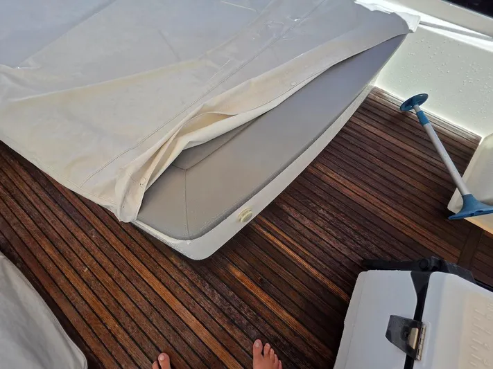 Just Peachy Yacht Photos Pics Teak deck of 2015 Prestige 550 Fly yacht with covered seating and cleaning tool.