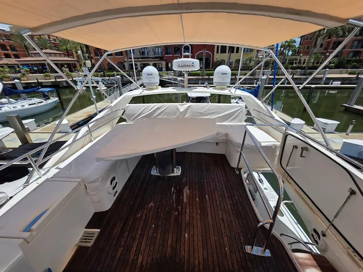 Just Peachy Yacht Photos Pics 2015 Prestige 550 Fly yacht deck with canopy, docked in a marina.