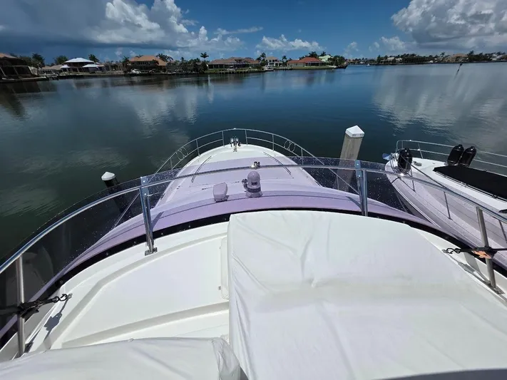 Just Peachy Yacht Photos Pics Prestige 550 Fly yacht on calm water, 2015 model, with scenic waterfront view.