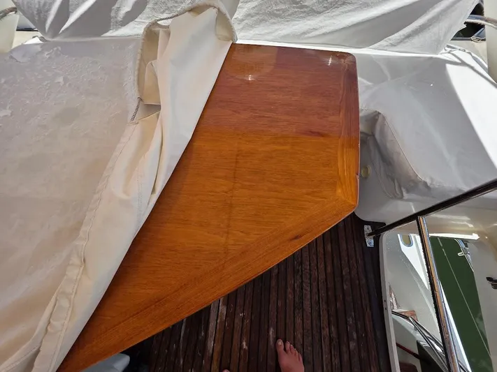 Just Peachy Yacht Photos Pics Polished wooden table on 2015 Prestige 550 Fly yacht deck, partially covered.