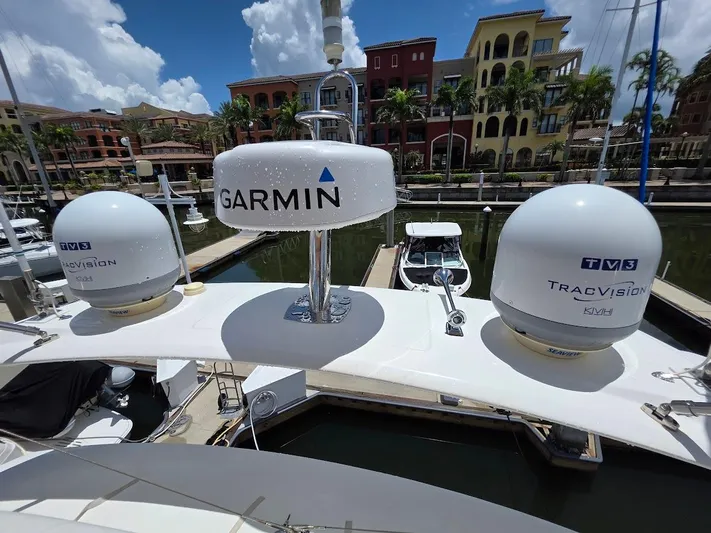 Just Peachy Yacht Photos Pics Prestige 550 Fly yacht with Garmin and TracVision satellite domes, docked in a marina.