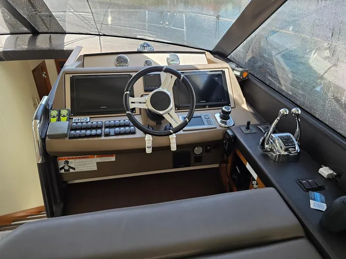 Just Peachy Yacht Photos Pics Cockpit of 2015 Prestige 550 Fly yacht with steering wheel and control panels.