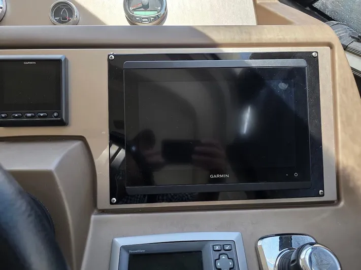Just Peachy Yacht Photos Pics Control panel of a 2015 Prestige 550 Fly yacht featuring Garmin navigation systems.