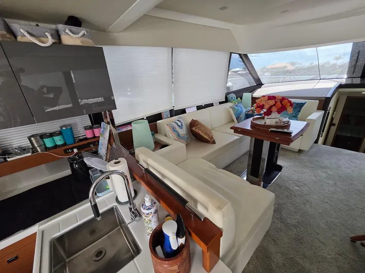 Just Peachy Yacht Photos Pics Luxurious interior of a 2015 Prestige 550 Fly yacht with modern kitchen and cozy seating area.