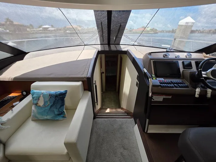 Just Peachy Yacht Photos Pics Interior of 2015 Prestige 550 Fly yacht with helm and seating area.