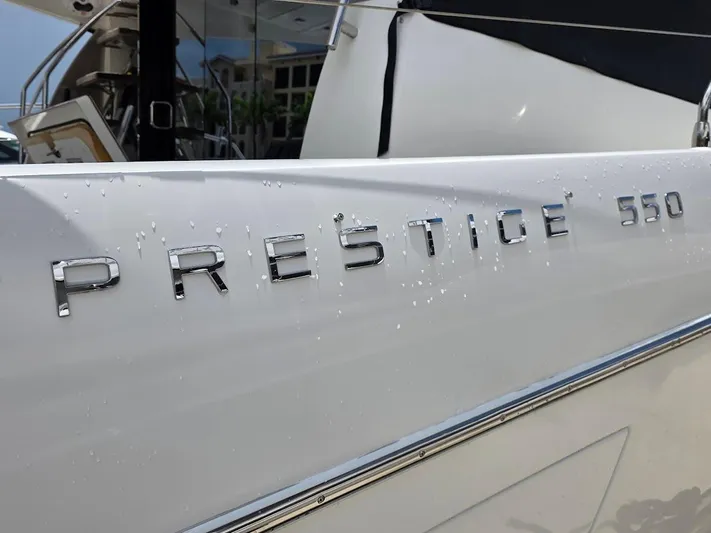 Just Peachy Yacht Photos Pics 2015 Prestige 550 Fly yacht with chrome lettering and water droplets.