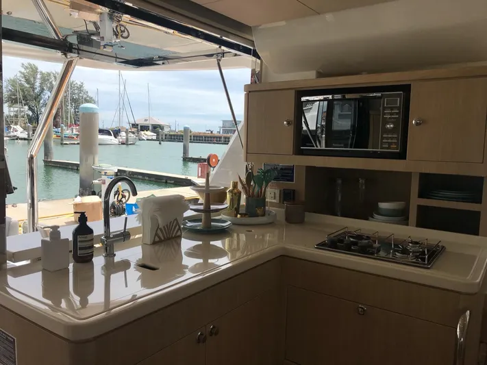 Charis Yacht Photos Pics Modern kitchen interior on 2020 Aquila 44 Yacht, overlooking marina.