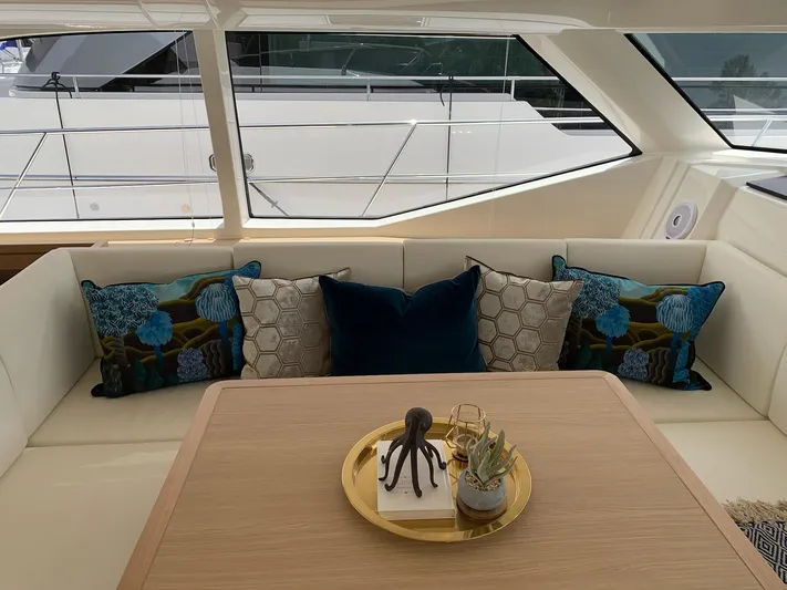 Charis Yacht Photos Pics Luxurious interior of 2020 Aquila 44 Yacht with decorative pillows and elegant table setting.