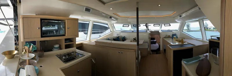 Charis Yacht Photos Pics Luxurious interior of 2020 Aquila 44 Yacht with modern kitchen and panoramic windows.