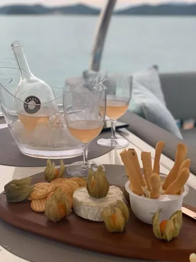 Charis Yacht Photos Pics Cheese and wine setup on Aquila 44 Yacht, 2020, with crackers and breadsticks.