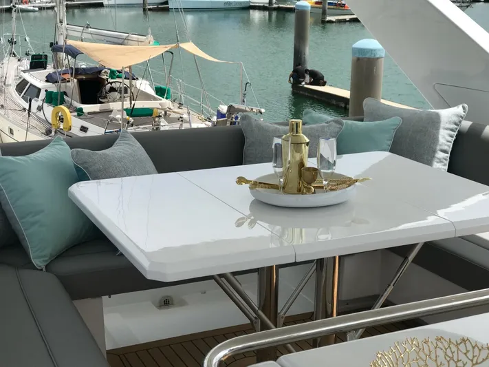 Charis Yacht Photos Pics Luxurious seating area on 2020 Aquila 44 Yacht with elegant table setting.