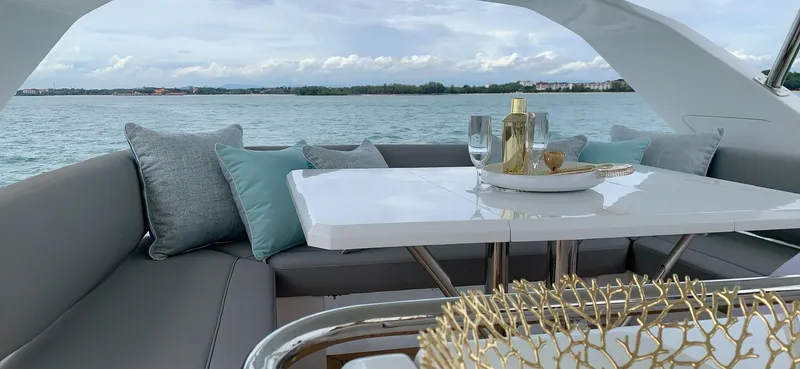 Charis Yacht Photos Pics Luxurious seating area on 2020 Aquila 44 Yacht with elegant tableware and scenic ocean view.