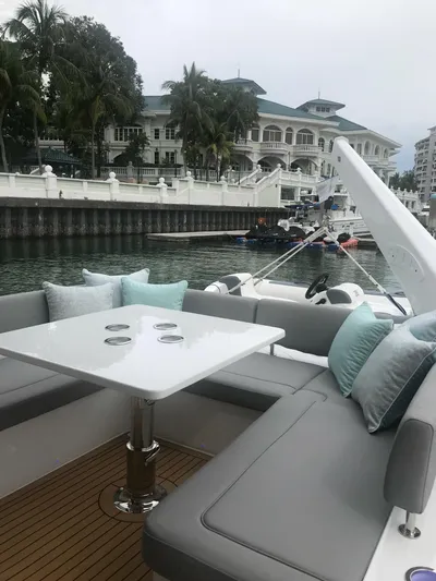 Charis Yacht Photos Pics Luxurious 2020 Aquila 44 Yacht with elegant seating and scenic waterfront view.