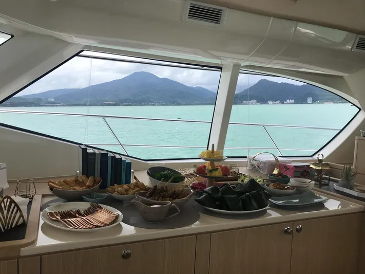 Charis Yacht Photos Pics Luxurious dining setup on 2020 Aquila 44 Yacht with scenic ocean view.