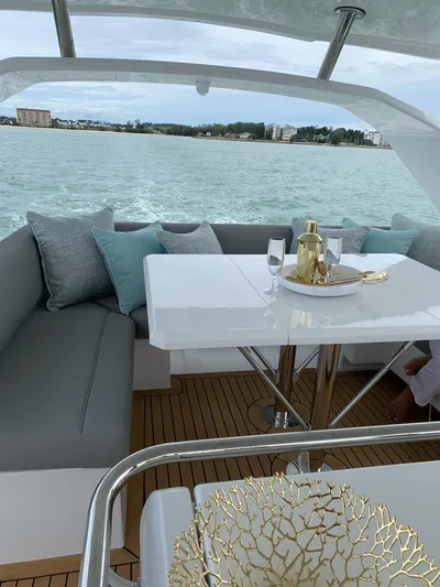 Charis Yacht Photos Pics Luxurious Aquila 44 Yacht interior with elegant seating and table setup, 2020 model.