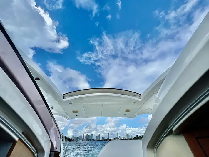 Naomi Yacht Photos Pics 2014 Fairline Targa 38 Open yacht with city skyline and blue sky background.