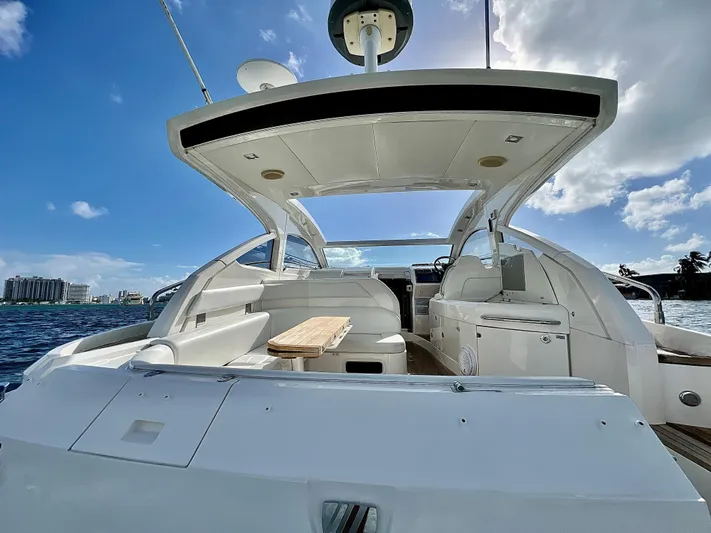 Naomi Yacht Photos Pics 2014 Fairline Targa 38 Open yacht with spacious deck, under clear blue sky.