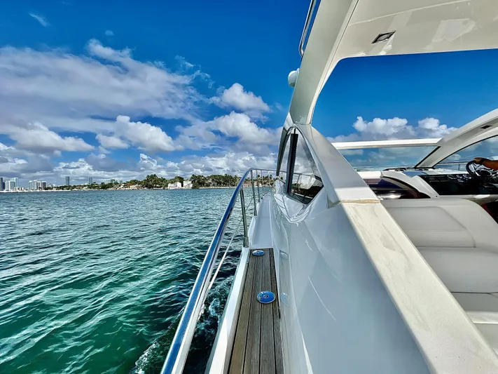 Naomi Yacht Photos Pics 2014 Fairline Targa 38 Open yacht cruising on a sunny day with blue skies.