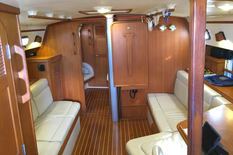 Texas Yacht Photos Pics Interior of 2001 Island Packet 420 sailboat with wooden finish and white seating.