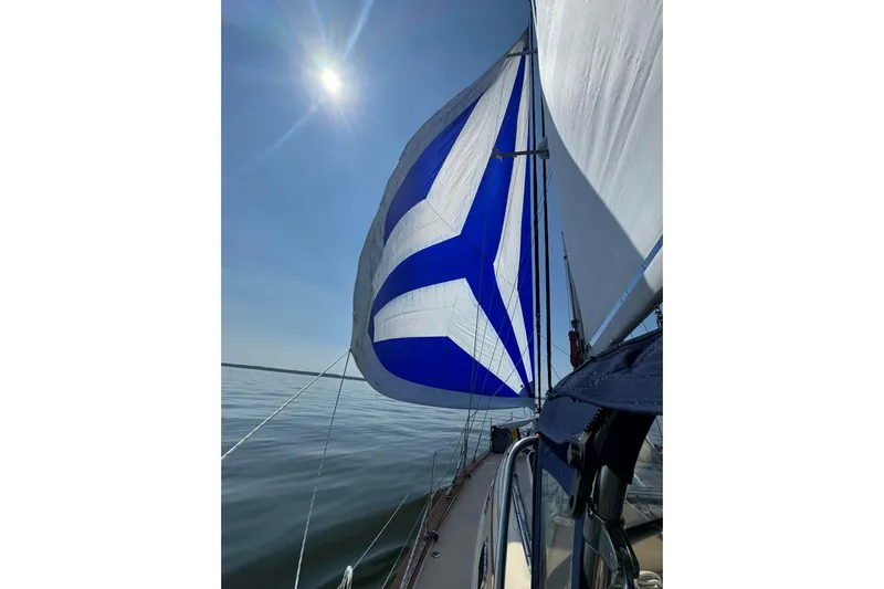 Texas Yacht Photos Pics Sailing on a 2001 Island Packet 420 with vibrant blue and white sails under a sunny sky.