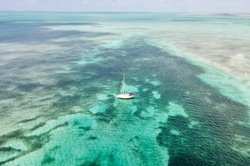 Texas Yacht Photos Pics Sailboat Island Packet 420 (2001) on turquoise ocean waters, aerial view.
