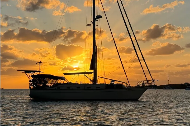 Texas Yacht Photos Pics Island Packet 420 sailboat silhouetted against a vibrant sunset, 2001 model.