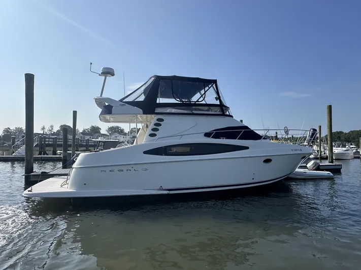 Yacht Photos Pics 2002 Regal 3880 yacht docked in a marina under clear blue skies.