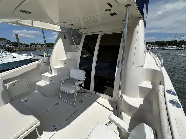  Yacht Photos Pics 2002 Regal 3880 yacht interior with seating, steps, and waterfront view.