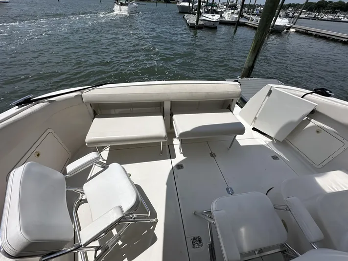  Yacht Photos Pics 2002 Regal 3880 boat deck with white seating, docked at a marina.