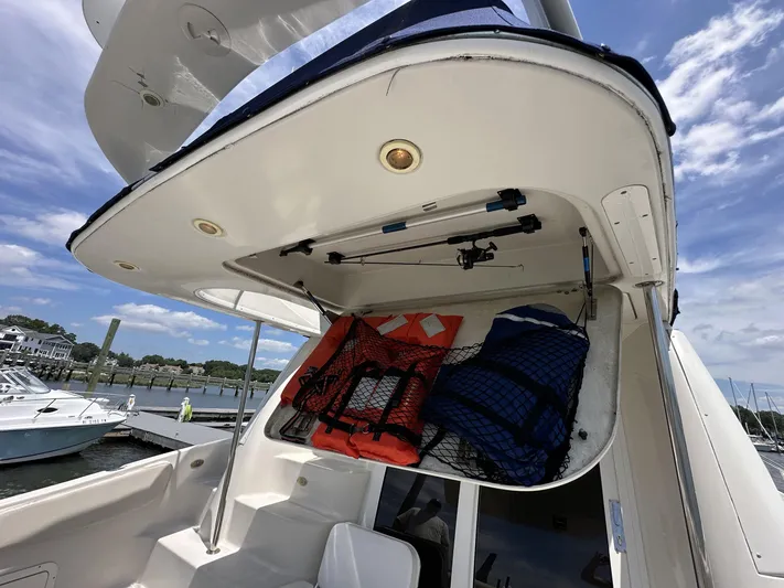  Yacht Photos Pics 2002 Regal 3880 boat storage area with life jackets and fishing rods.