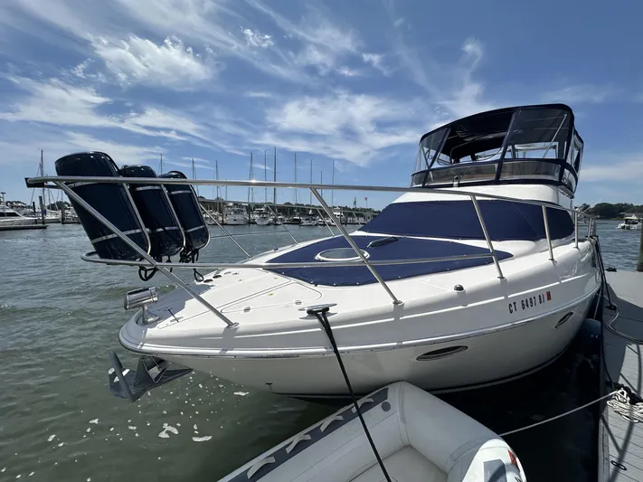  Yacht Photos Pics 2002 Regal 3880 yacht docked at marina under blue sky.