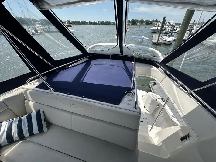  Yacht Photos Pics 2002 Regal 3880 yacht interior with blue canopy, docked at marina.