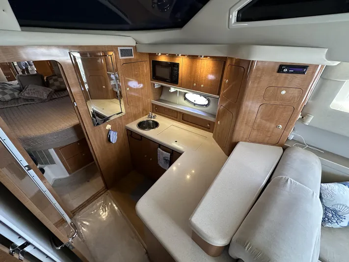  Yacht Photos Pics Interior of 2002 Regal 3880 yacht with kitchenette and cozy sleeping area.