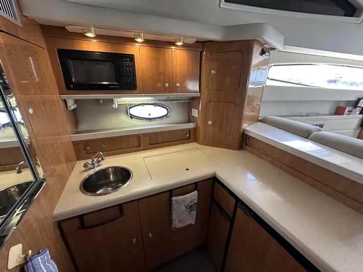  Yacht Photos Pics Luxurious 2002 Regal 3880 yacht kitchen with wood cabinetry and modern appliances.