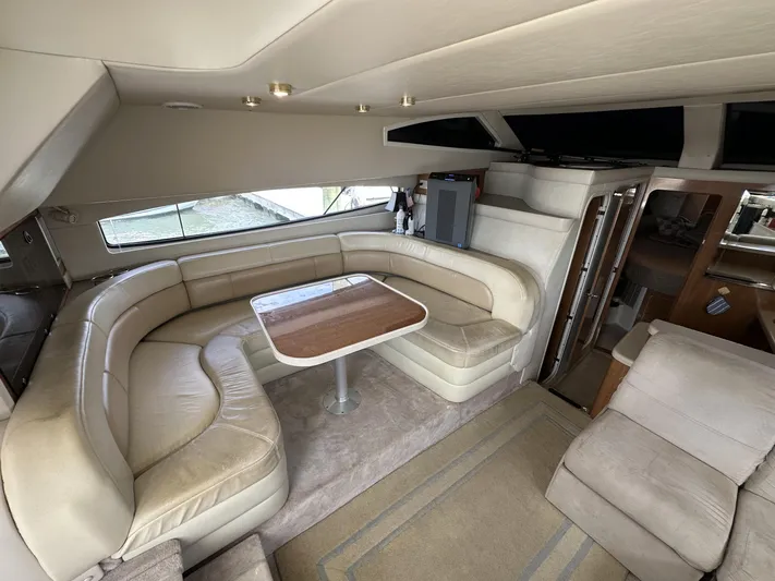  Yacht Photos Pics Luxurious interior of a 2002 Regal 3880 yacht with plush seating and wooden table.