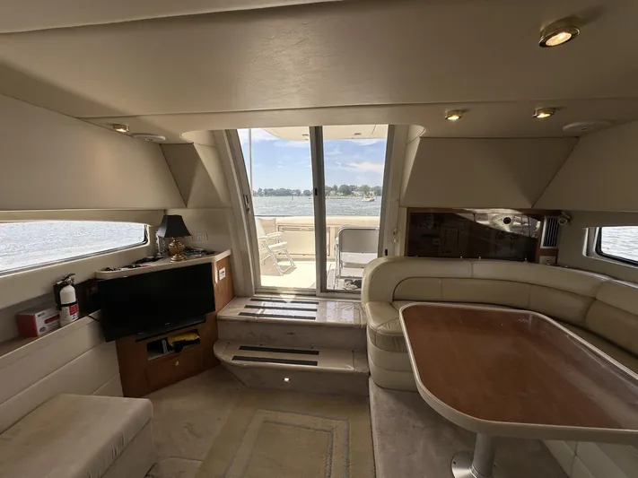  Yacht Photos Pics Interior of 2002 Regal 3880 yacht with seating, table, and water view.